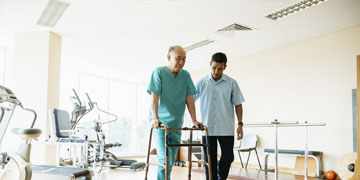 Elderly man receiving assisted daily living support for improved independence