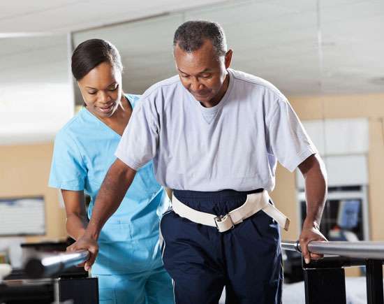 Caregiver assisting a patient with mobility support during rehabilitation, ensuring independence and safety in daily activities.